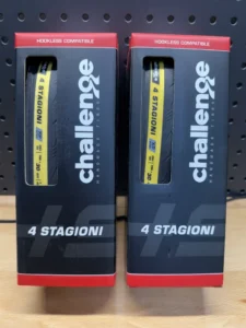 Two boxes containing bicycle wheels. The packaging says they are Challenge 4 Stagioni.
